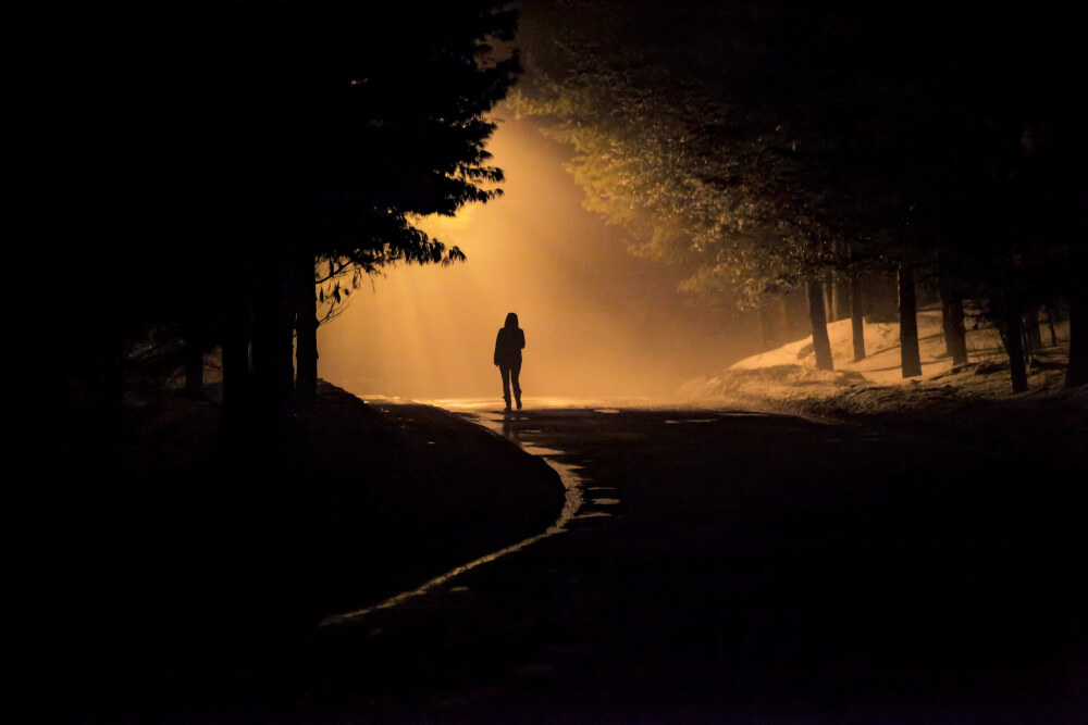 Woman Walking Alone Into Misty Foggy Road Dramatic Mystic Scene With Warm Colors