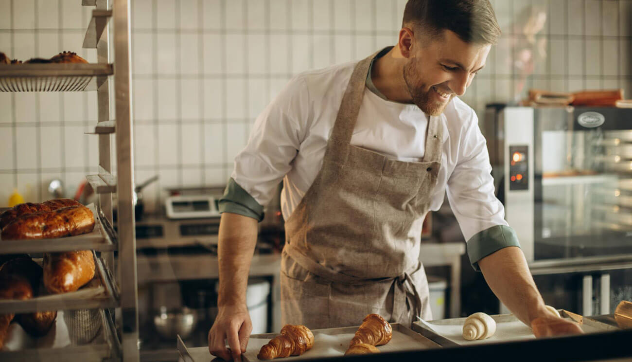 Handsome Baker Preparing Croissants Bake House
