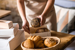 Impeccable Quality Neat Female Hands Carefully Packing Bread 300x200