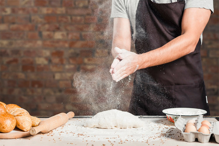 Male Baker S Hand Dusting Flour Kneaded Dough Kitchen Worktop